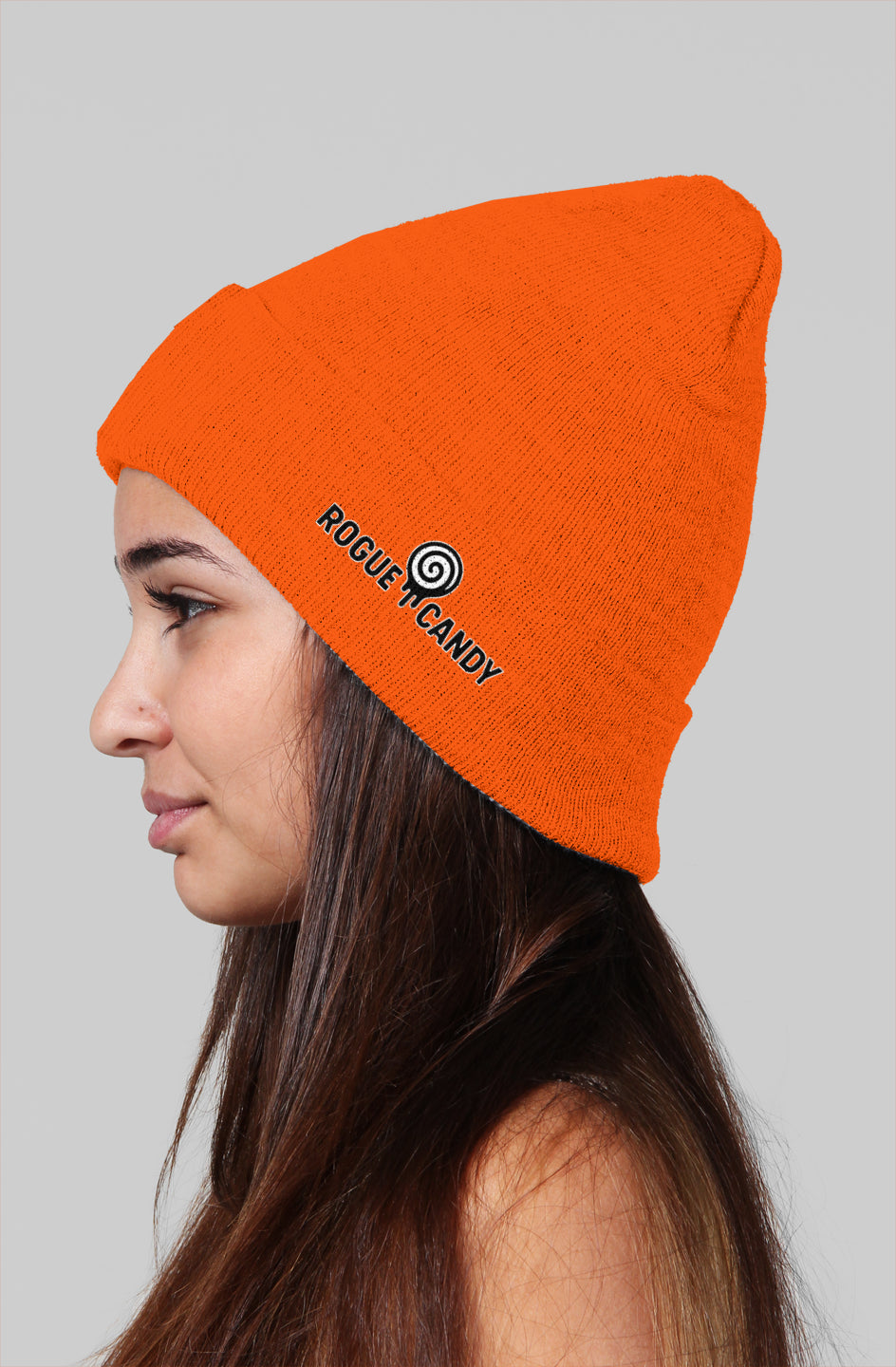 Girl wearing, Rogue Candy embroidered logo, on side orange Beanie