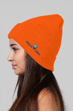 Girl wearing, Rogue Candy embroidered logo, on side orange Beanie