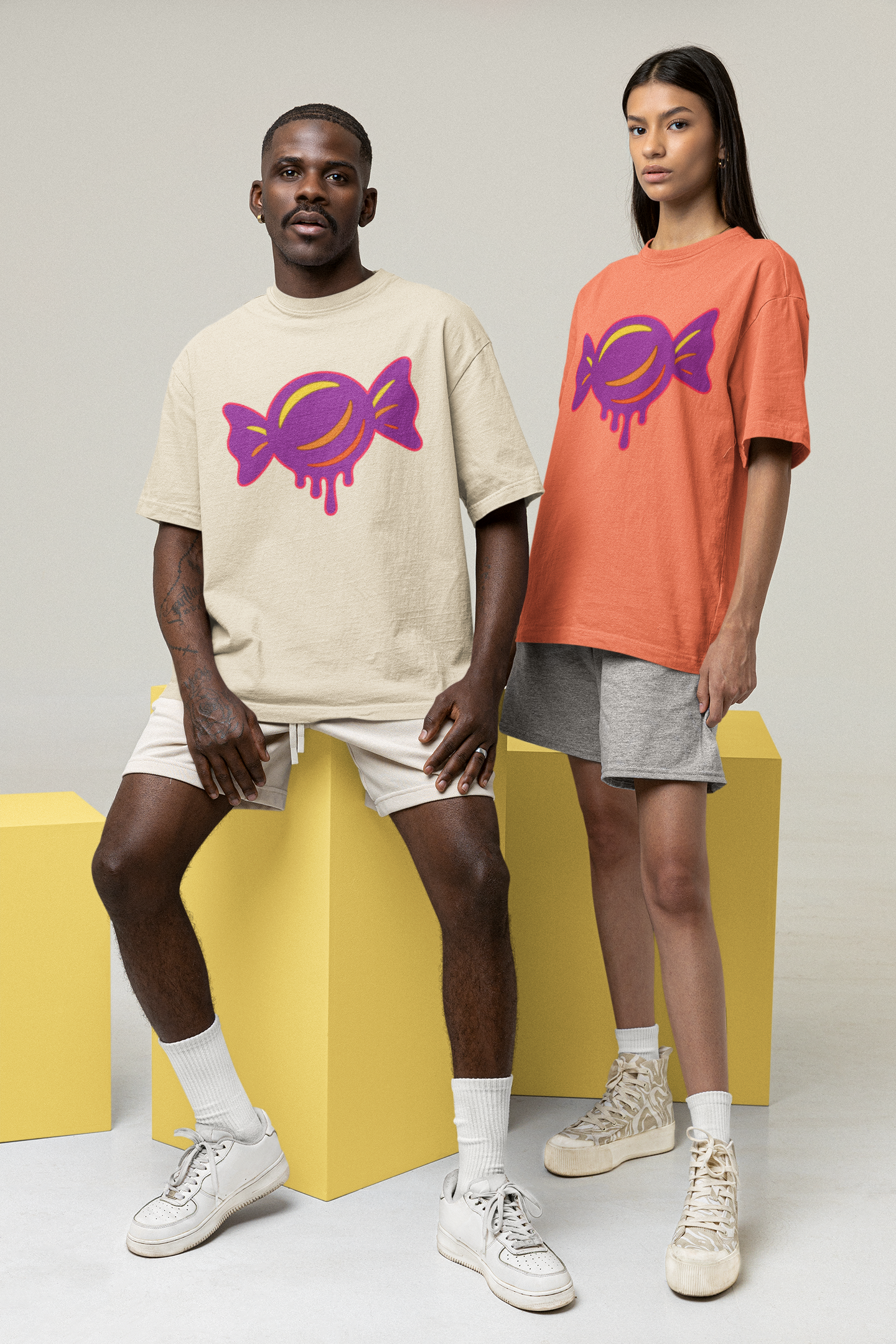 Two people wearing t-shirts with colorful graphic designs on a plain background