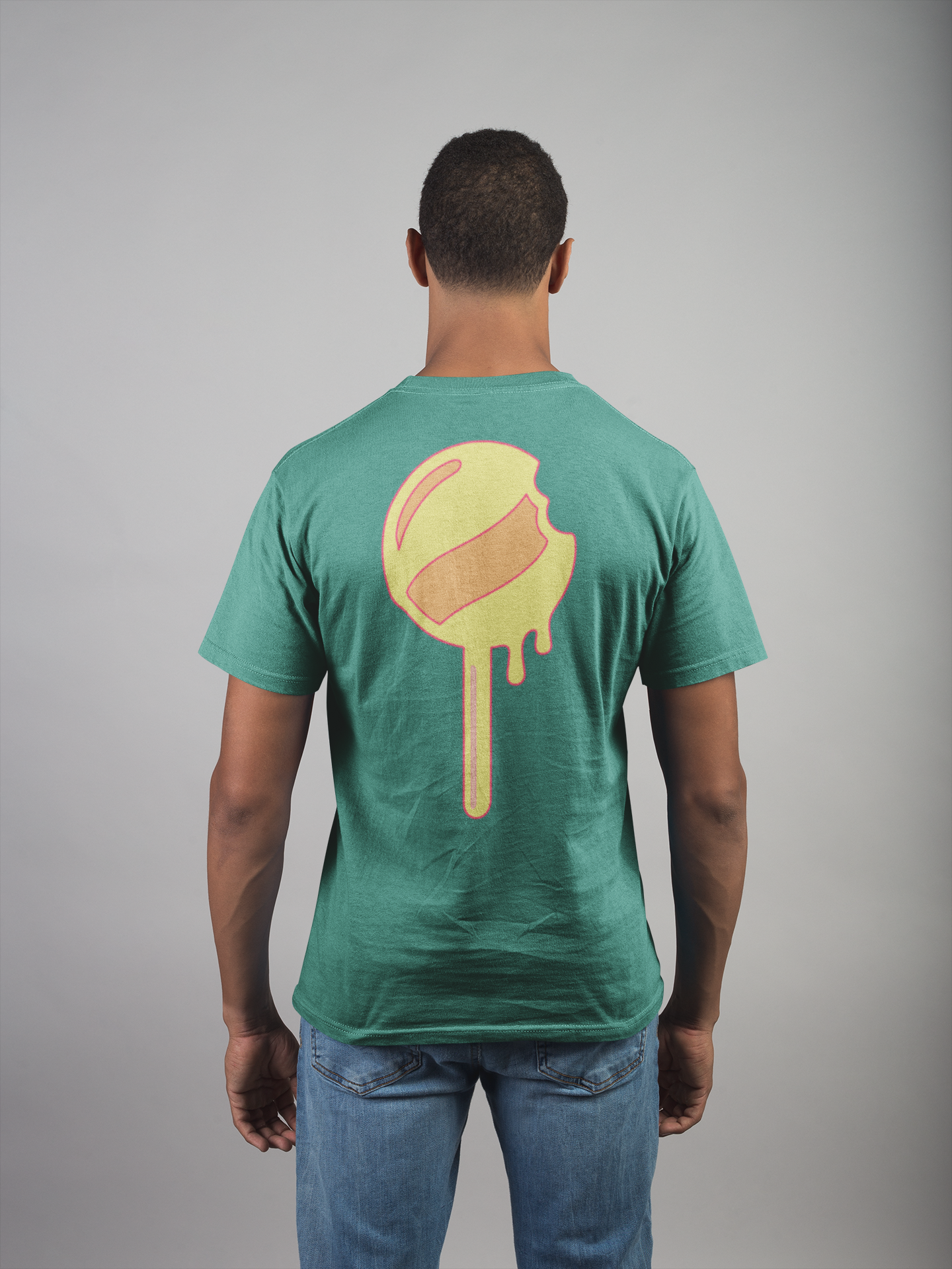 Man wearing a green t-shirt with a yellow graphic on the back against a gray background