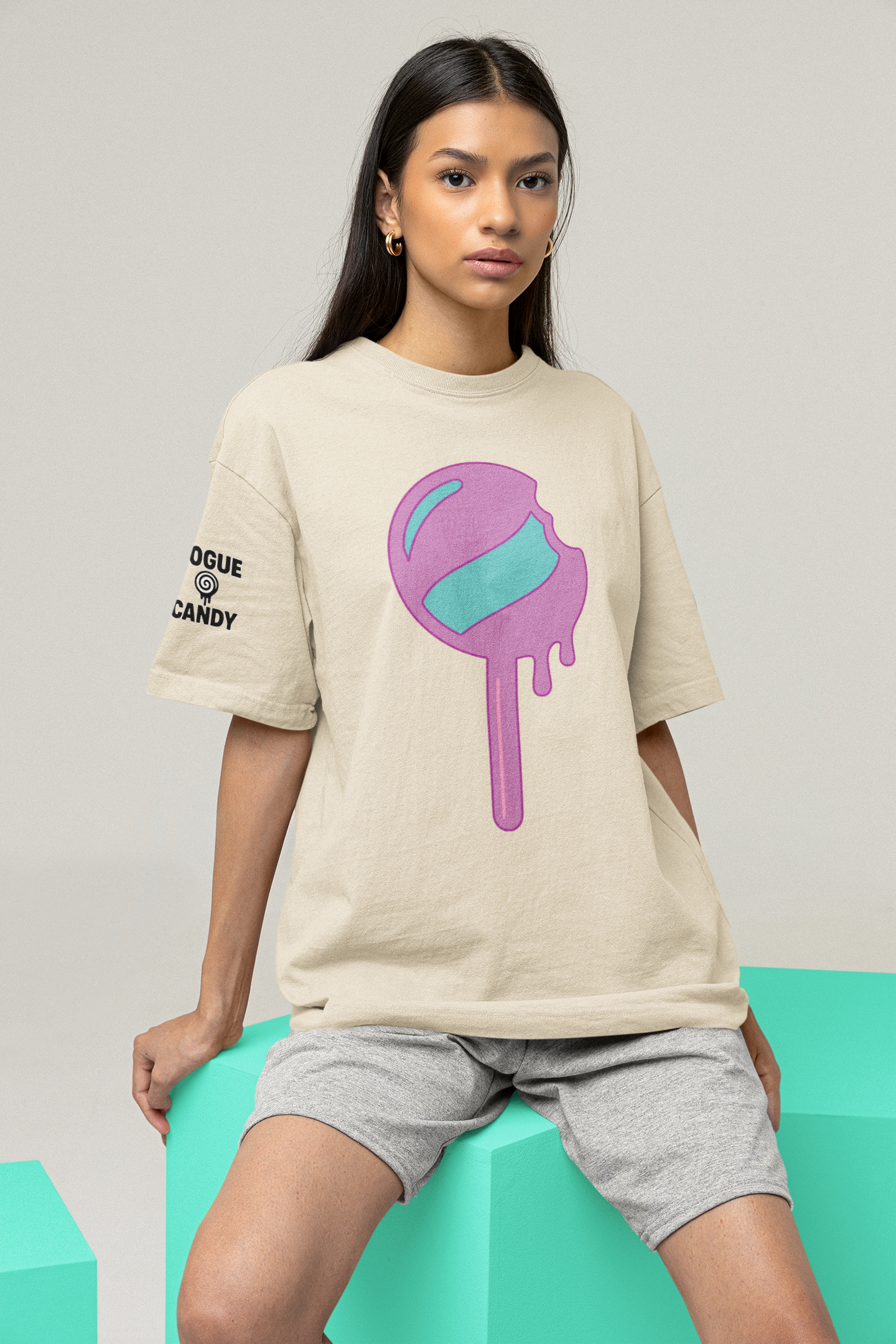 Person wearing a beige t-shirt with a colorful graphic design on a light gray background