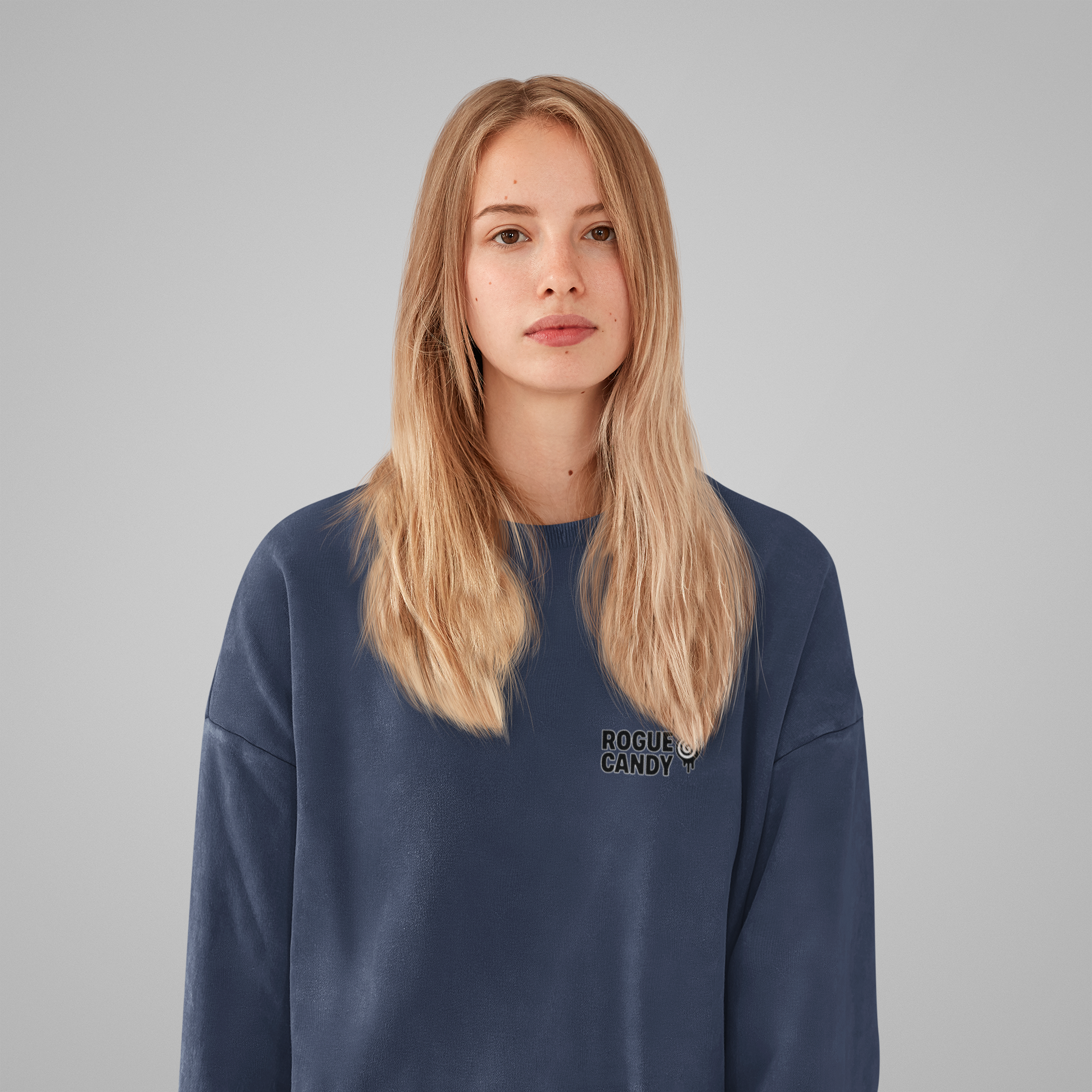 Person wearing a navy blue sweatshirt with 'Rogue Candy' logo on a gray background