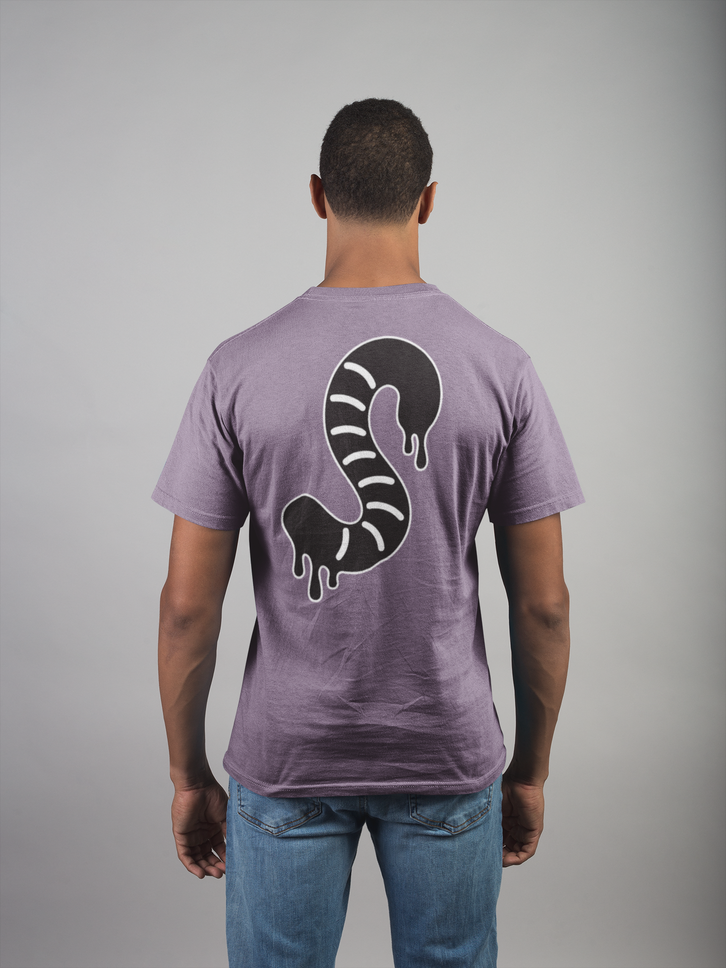 Man wearing a purple t-shirt with a black and white gummy worm design on the back against a gray background