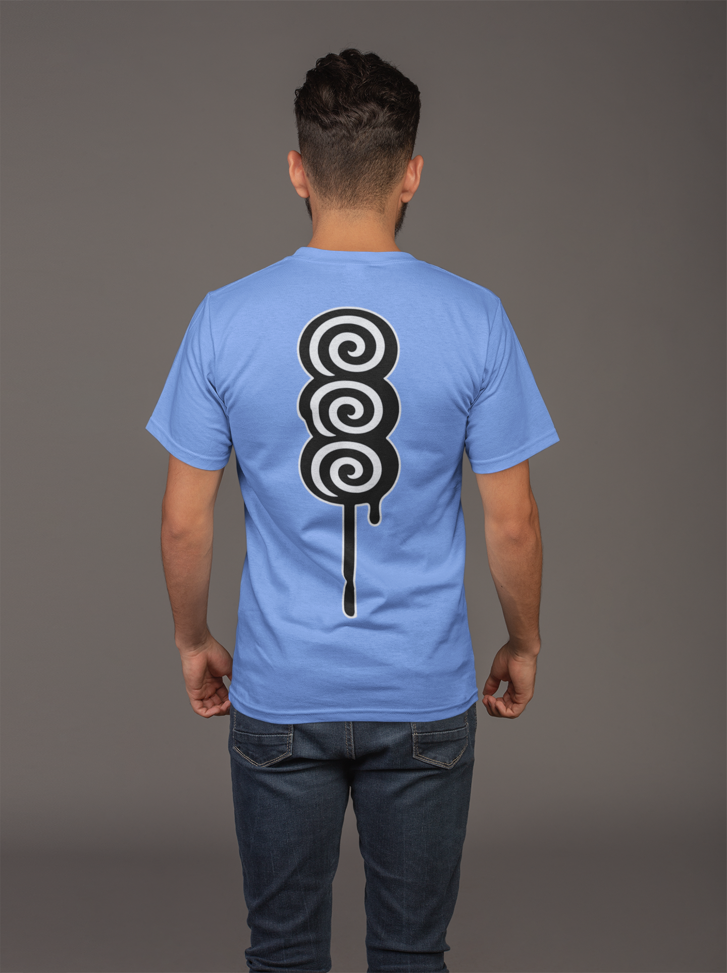Person wearing a light blue t-shirt with a black and white spiral design on the back against a gray background